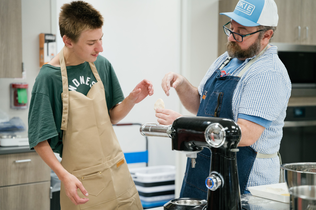 Student and teacher making homemade pasta noodles
