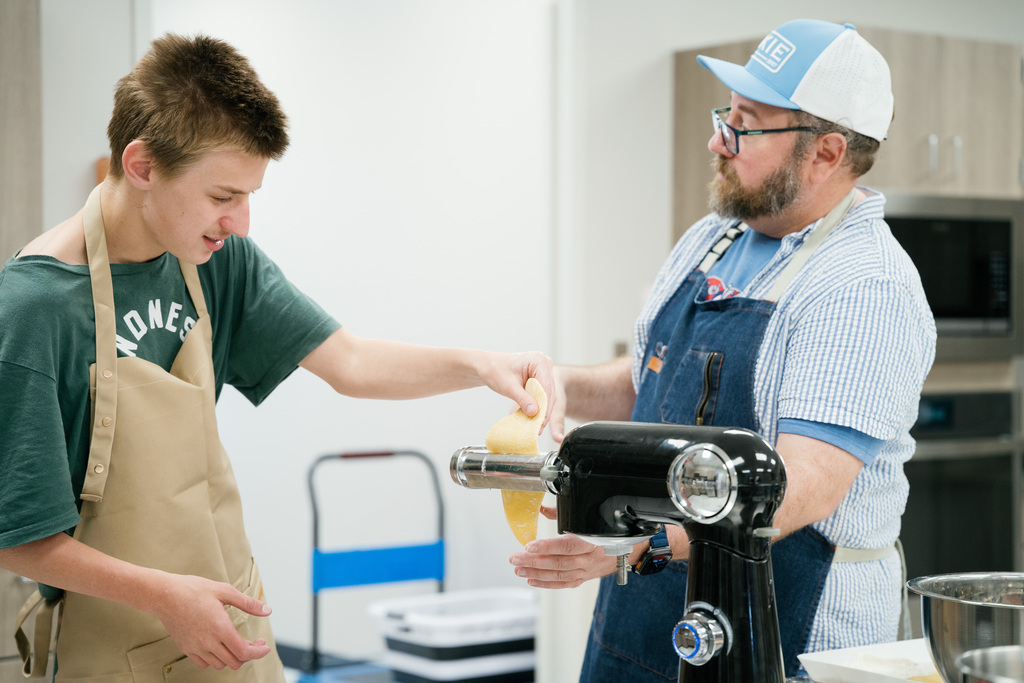 Student and teacher making homemade pasta noodles