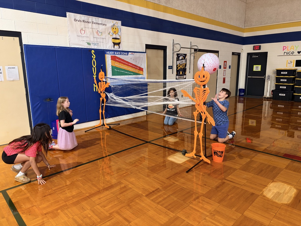 students playing volleyball with halloween props