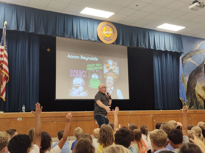 author speaking to students