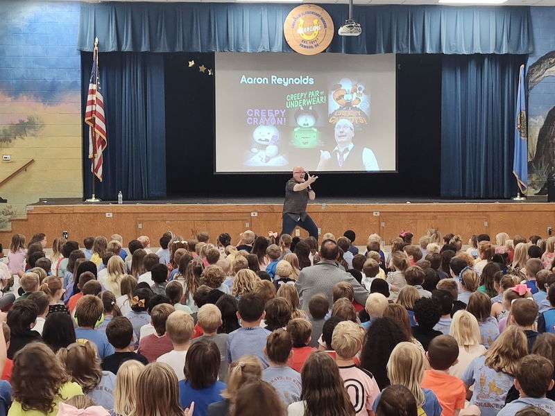 author speaking to students