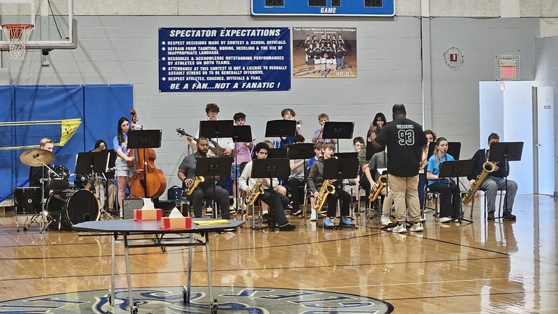 Jazz band performing in the gym for 5th grade visits.