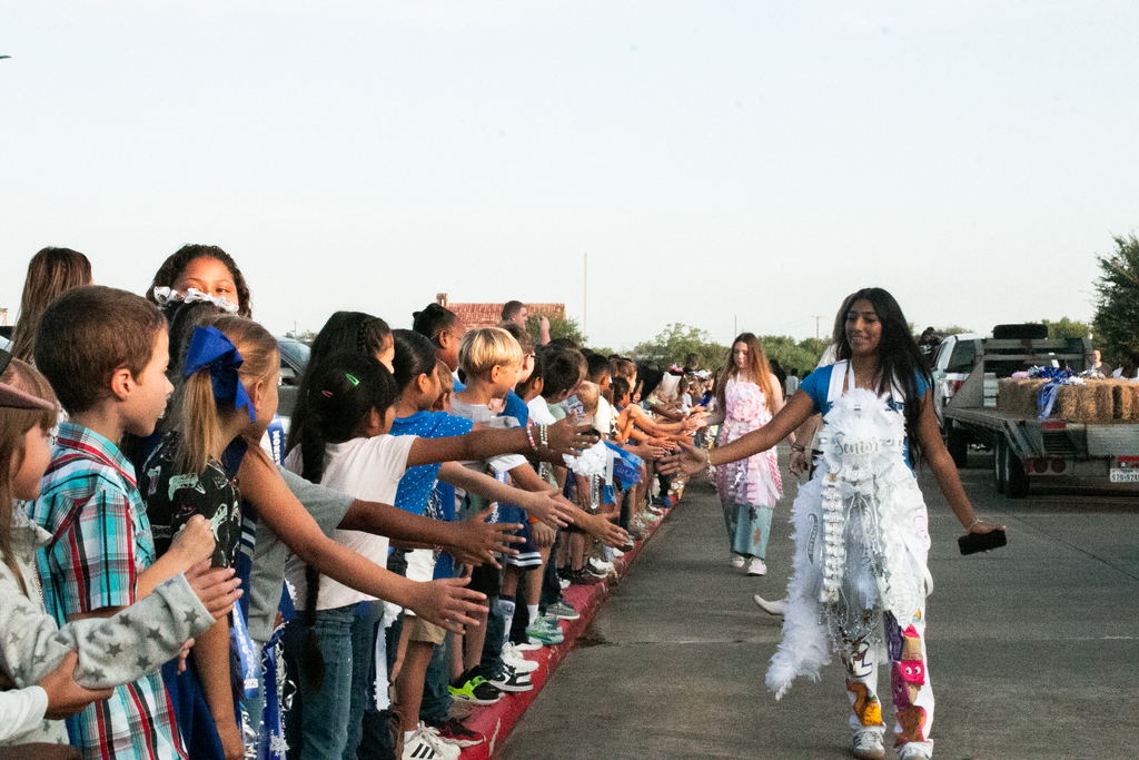 💙🤠 **LOOK WHO STOPPED BY!** 🤠💙 This morning, the **Homecoming Parade** stopped by the Elementary School, and our seniors, football players, cheerleaders, and dance team got to spend some time with our littlest Wranglers! 🐴💙 There were plenty of smiles, handshakes, and Homecoming spirit all around! 🏈🎉