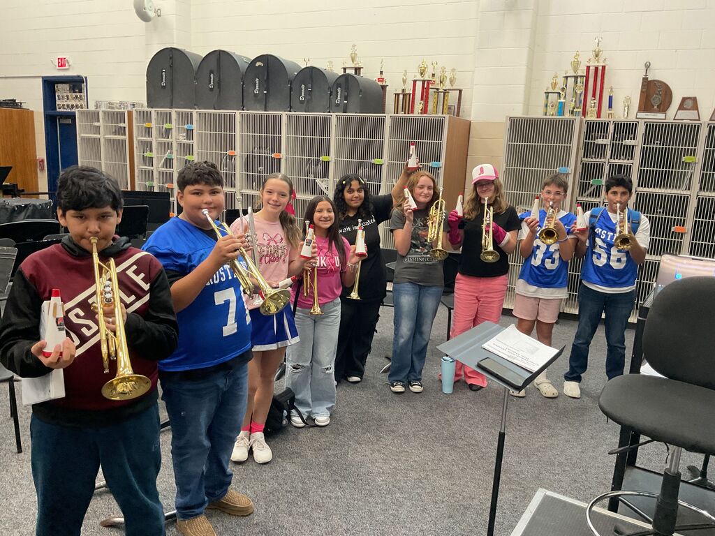 JH Wind Ensemble trumpet members with their new straight mutes.  They learned how a mute distorts their sounds for different sound effects.  Come hear them next Tuesday at their Fall Concert! 