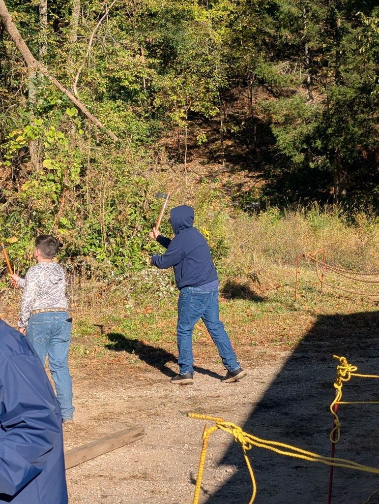 student throwing a hatchet