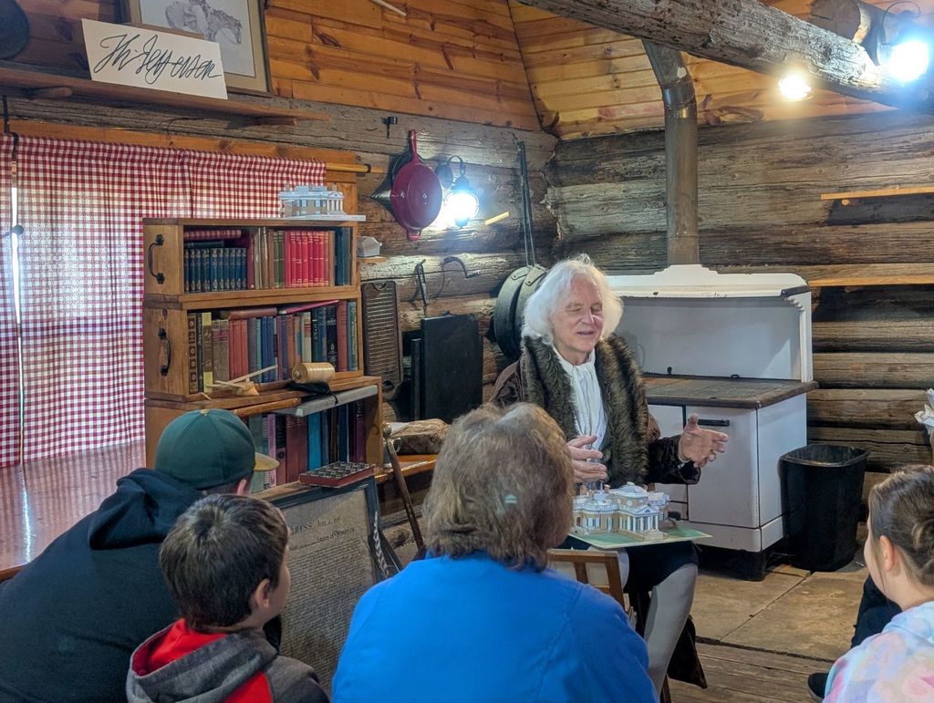 student listening to a reenactor 