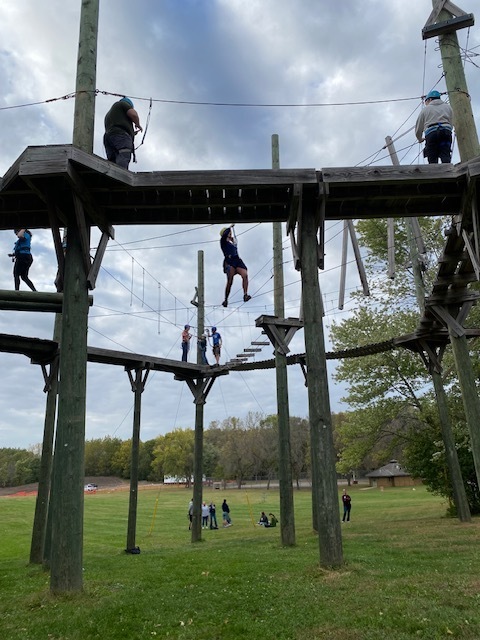 students on a ropes course, high in the air
