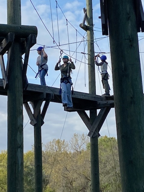 students on a ropes course, high in the air