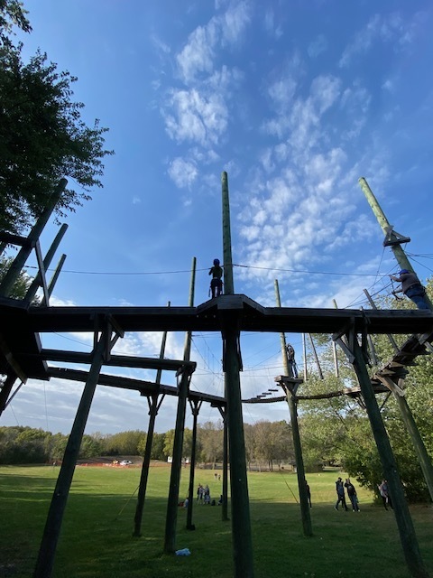 students on a ropes course, high in the air