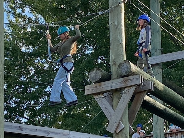 students on a ropes course, high in the air