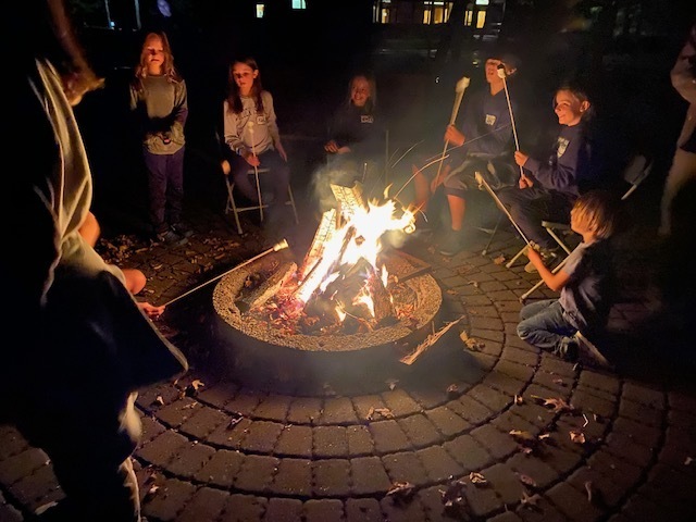 roasting smores around a campfire