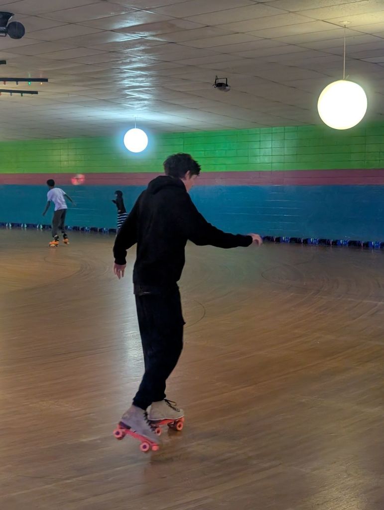 student in sweatshirt roller skating
