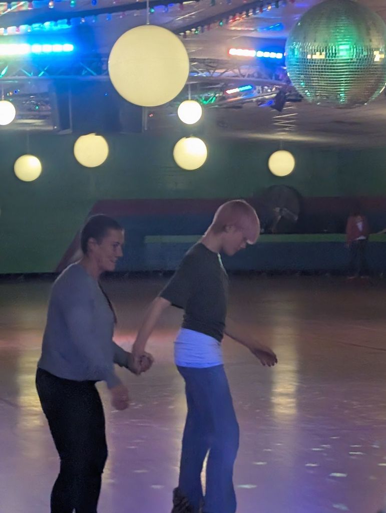 two people skating holding hands