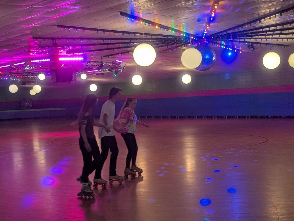 three students skating together