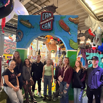 group photo in front of Can Can Wonderland sign