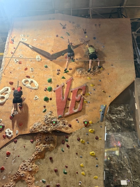 student rock climbing