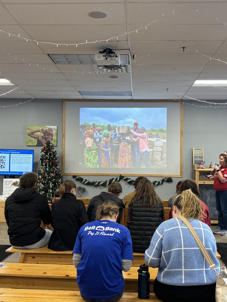 students watching a Feed my starving children presentation on a screen