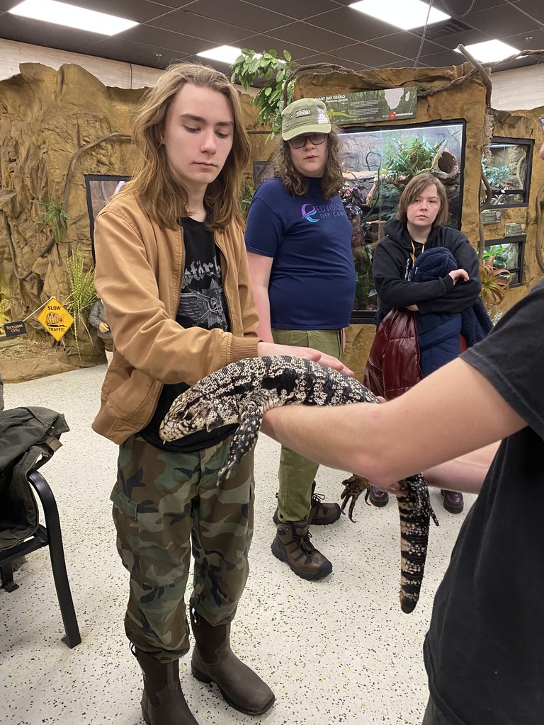 student petting a lizard