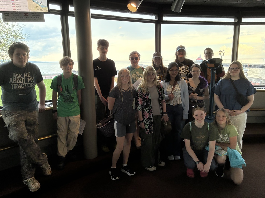 students in front of windows
