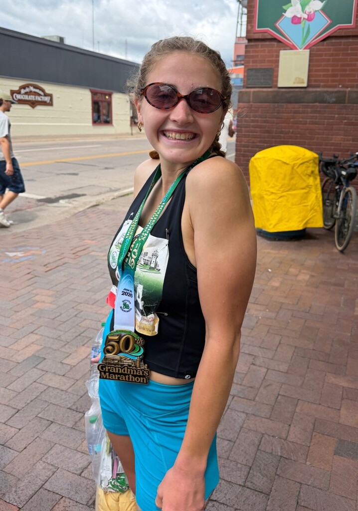 person smiling for the camera after running a race