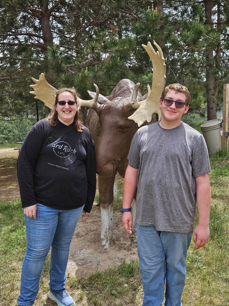two people by a moose