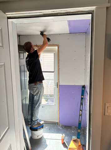 man fixing ceiling