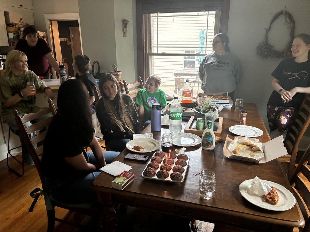 everyone around a table with cupcakes