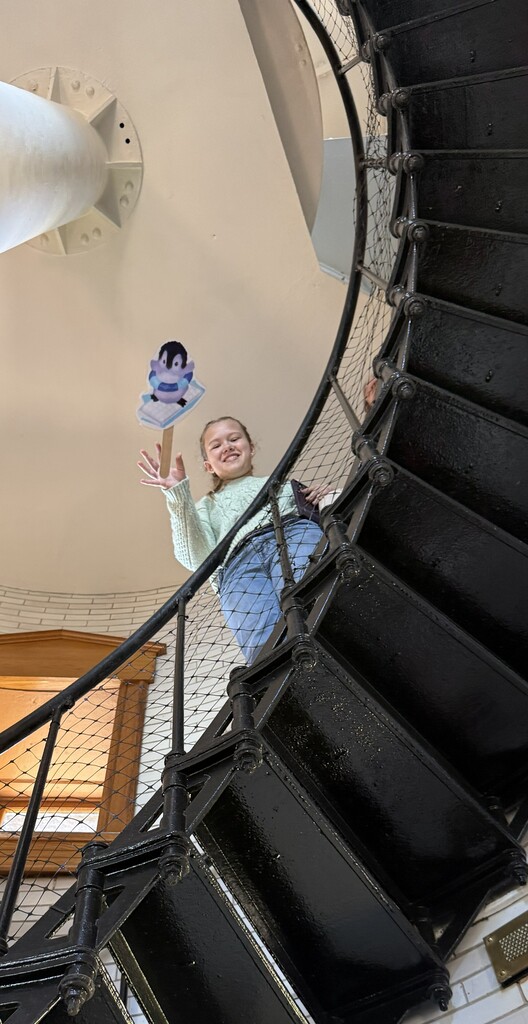 student holding mascot on stairs