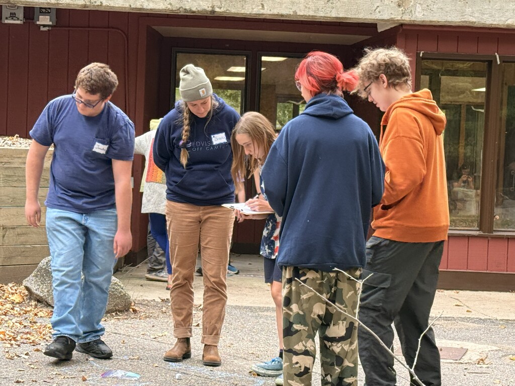 students working on activity together with clipboards