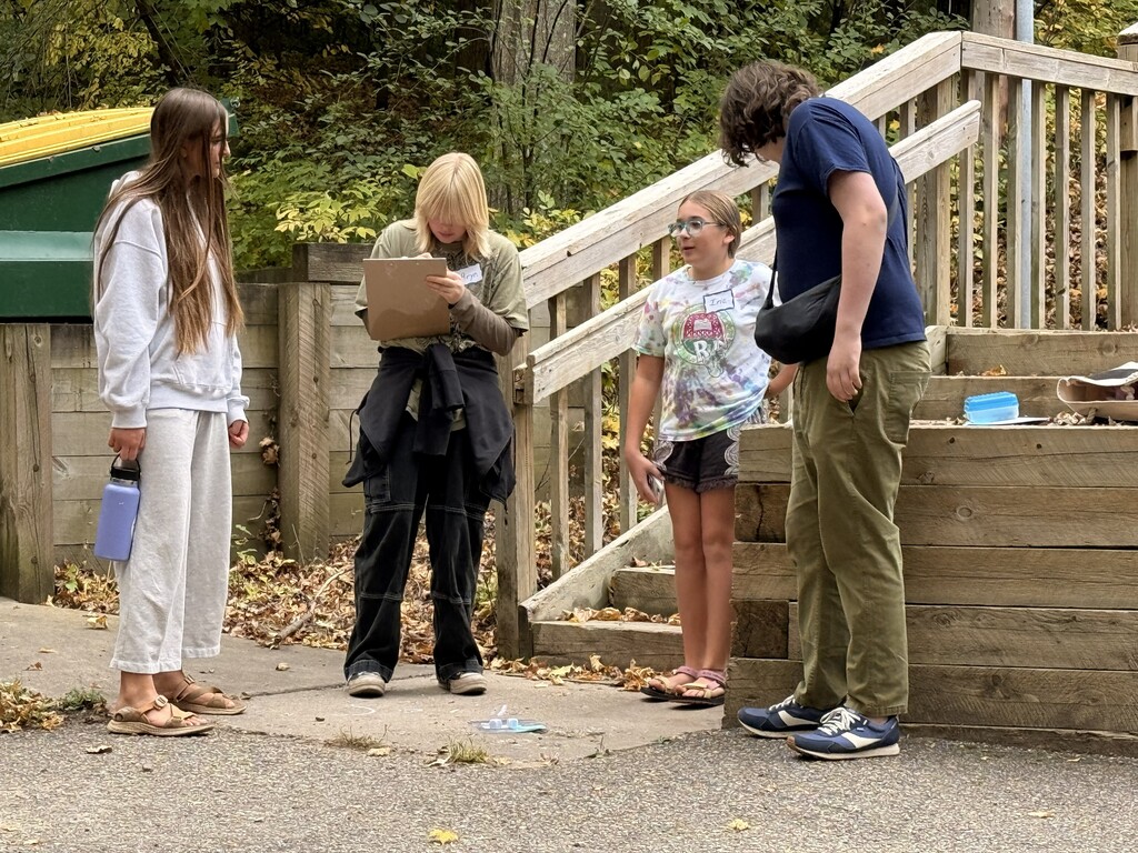 students working on activity together with clipboards