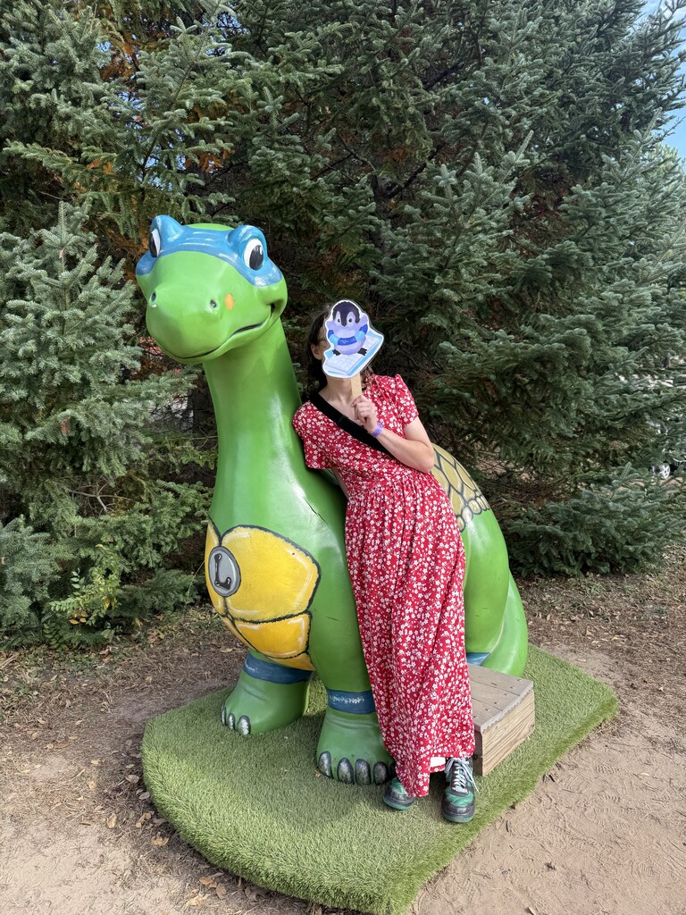 turtle painiting dinosaur and student with a red dress and a school mascot