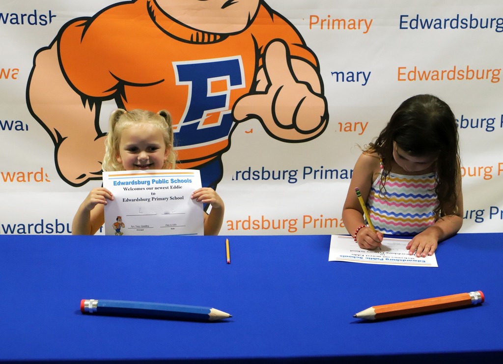 Students writing their name for Kindergarten Signing Day