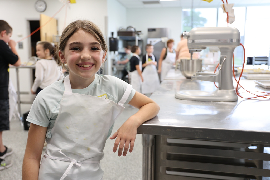 Girl leaning on culinary counter