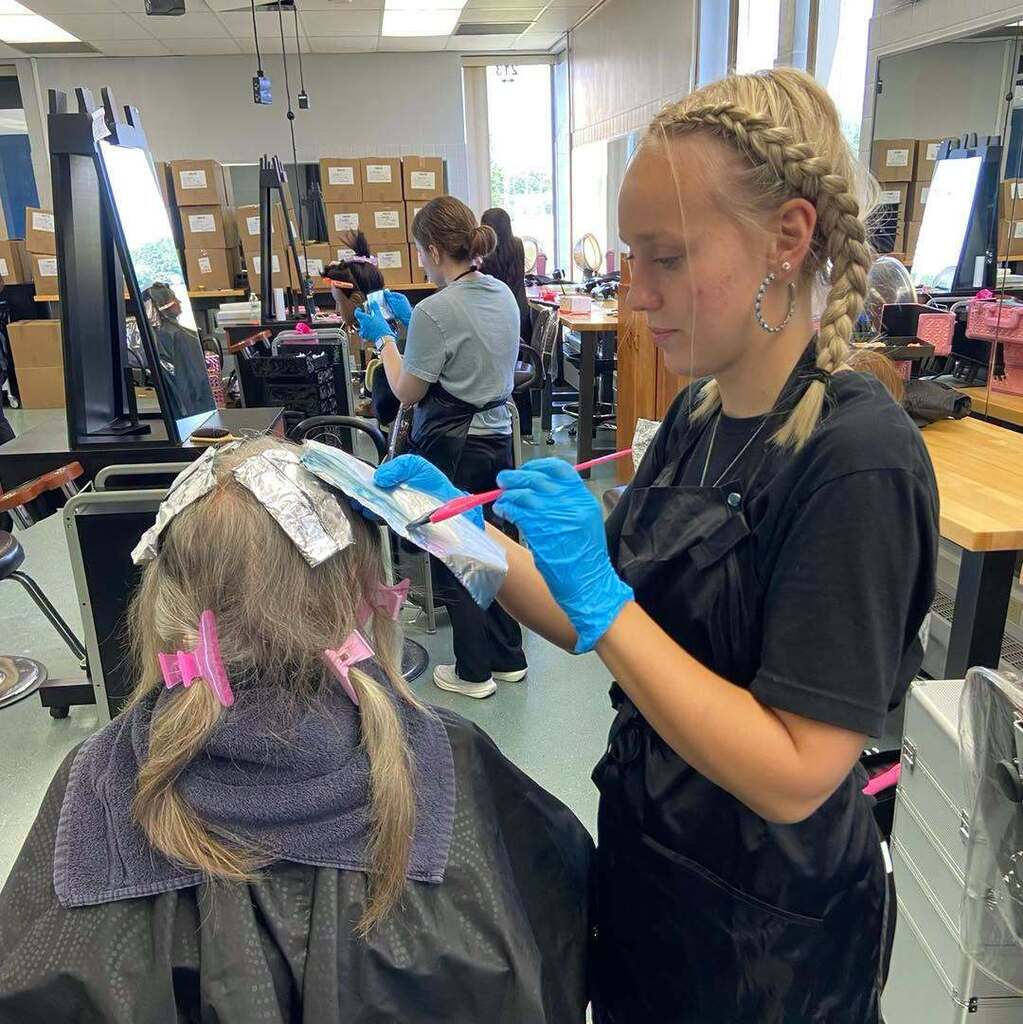 Cosmetology student dyeing hair