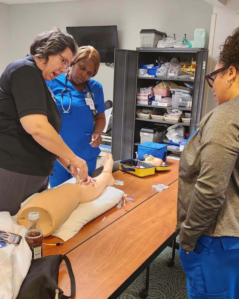 Nursing instructor teaching on a mannequin