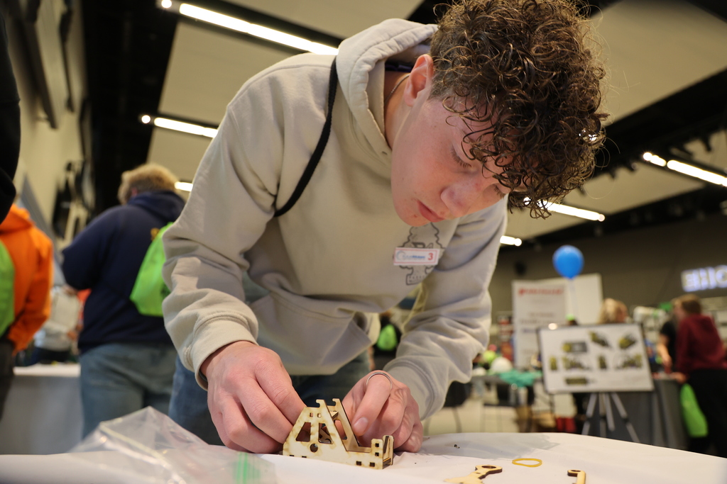 student building a tiny catapult