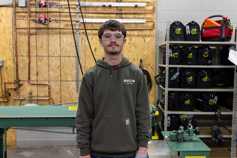 standing student with equipment and gear