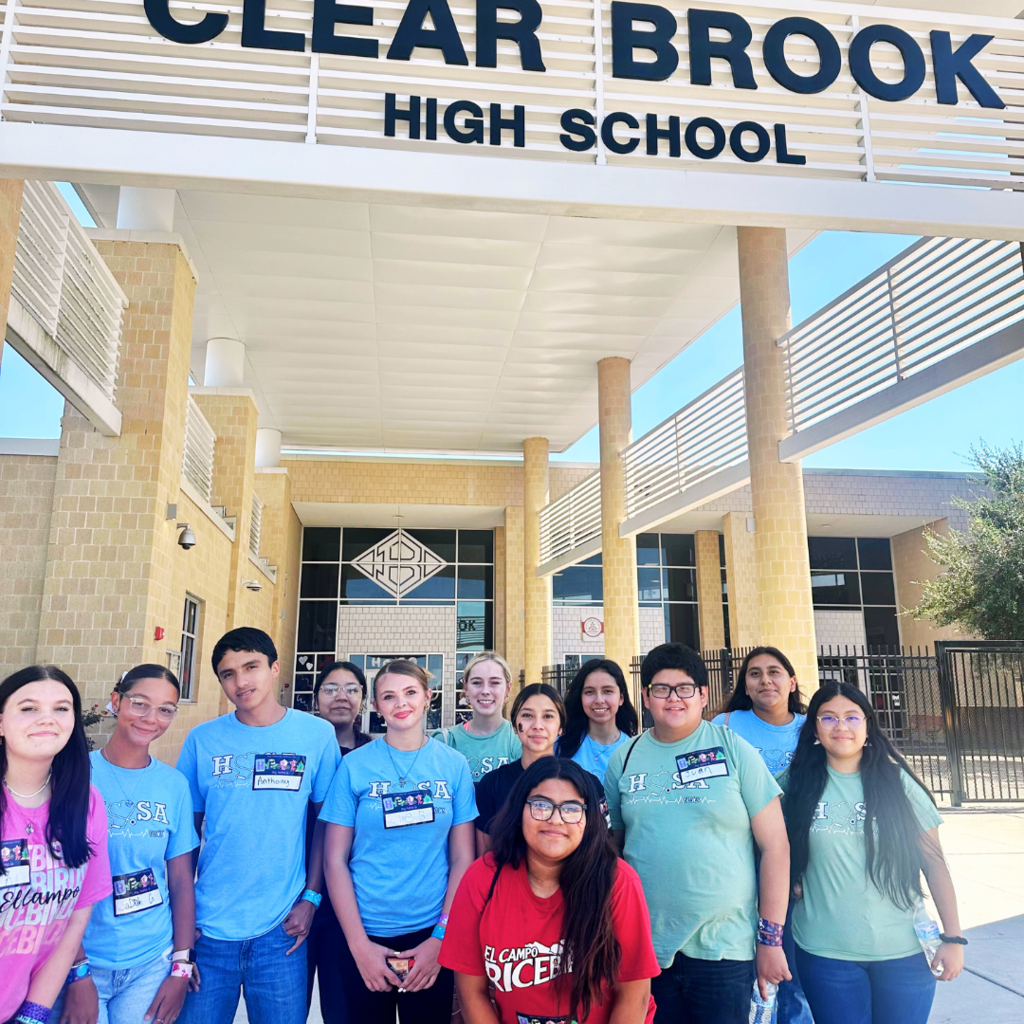 students grouped for picture at entrance of building