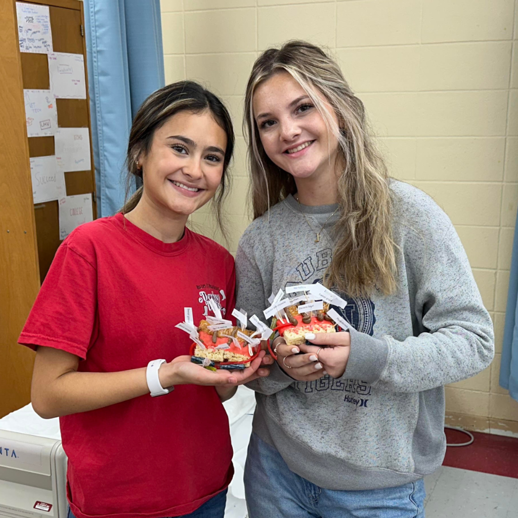 2 students showing their finished project