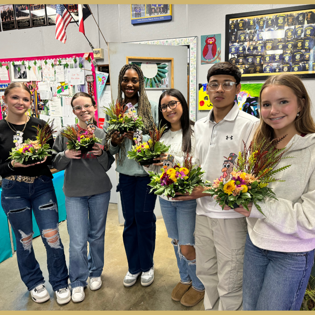 group of students holding their floral arrangement