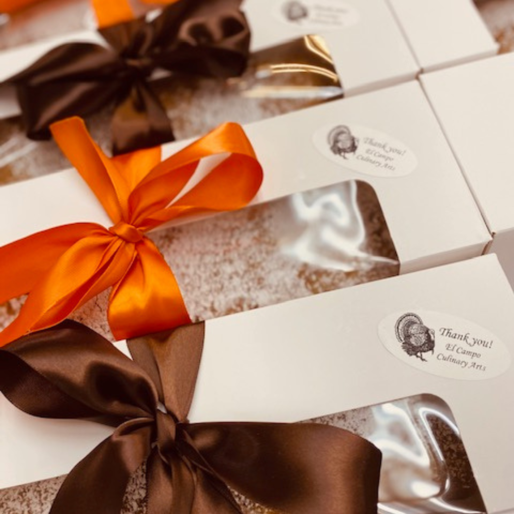 ribbon wrapped boxes ready to go with a thank you sticker