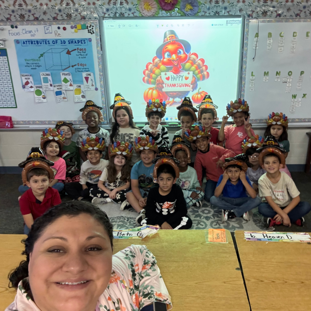selfie of the teacher with the class behind her