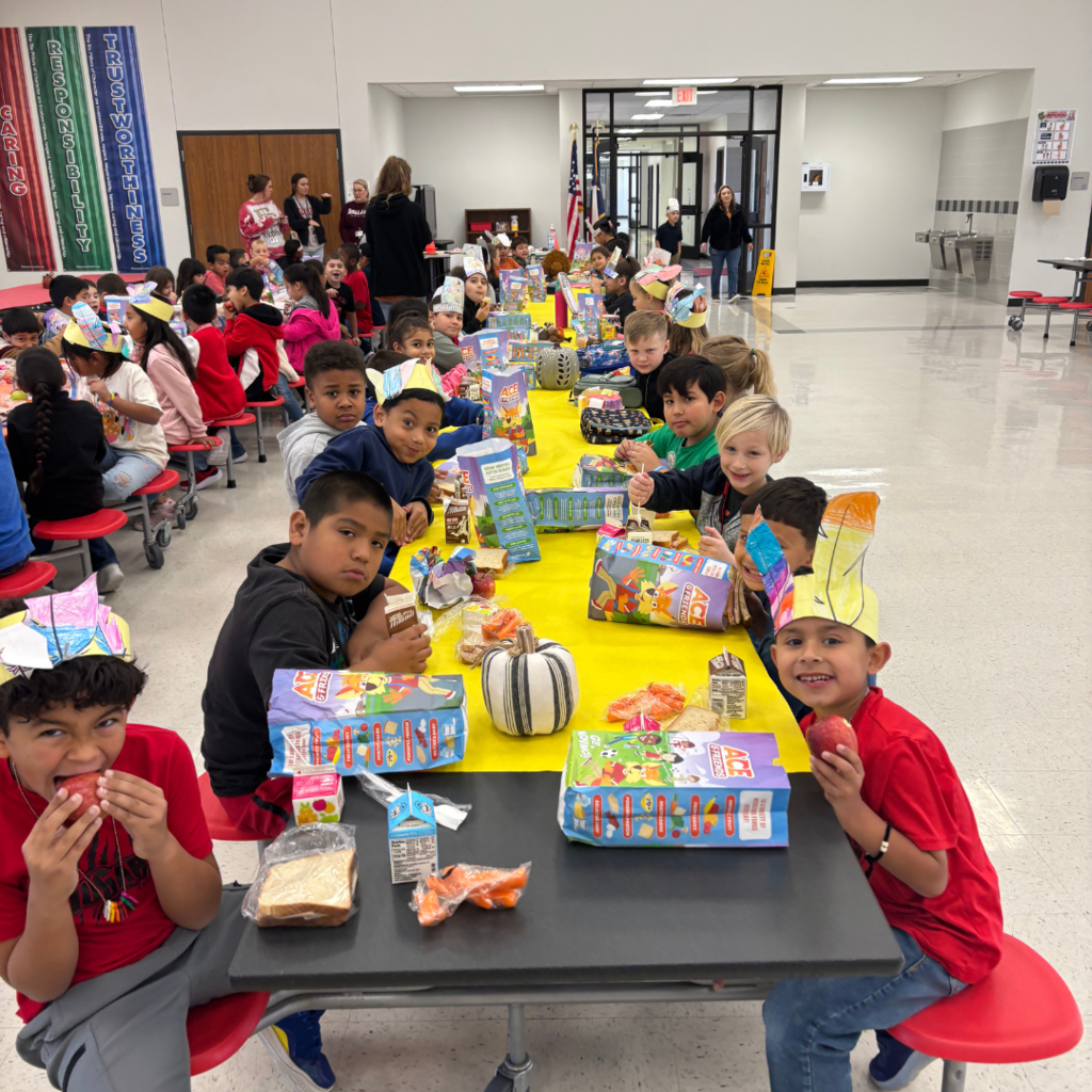 kids at cafeteria table covered with a tablecloth