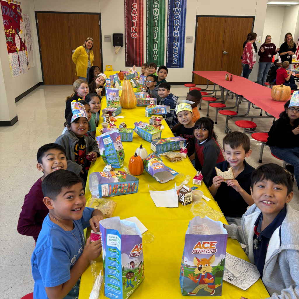 kids at cafeteria table covered with a tablecloth