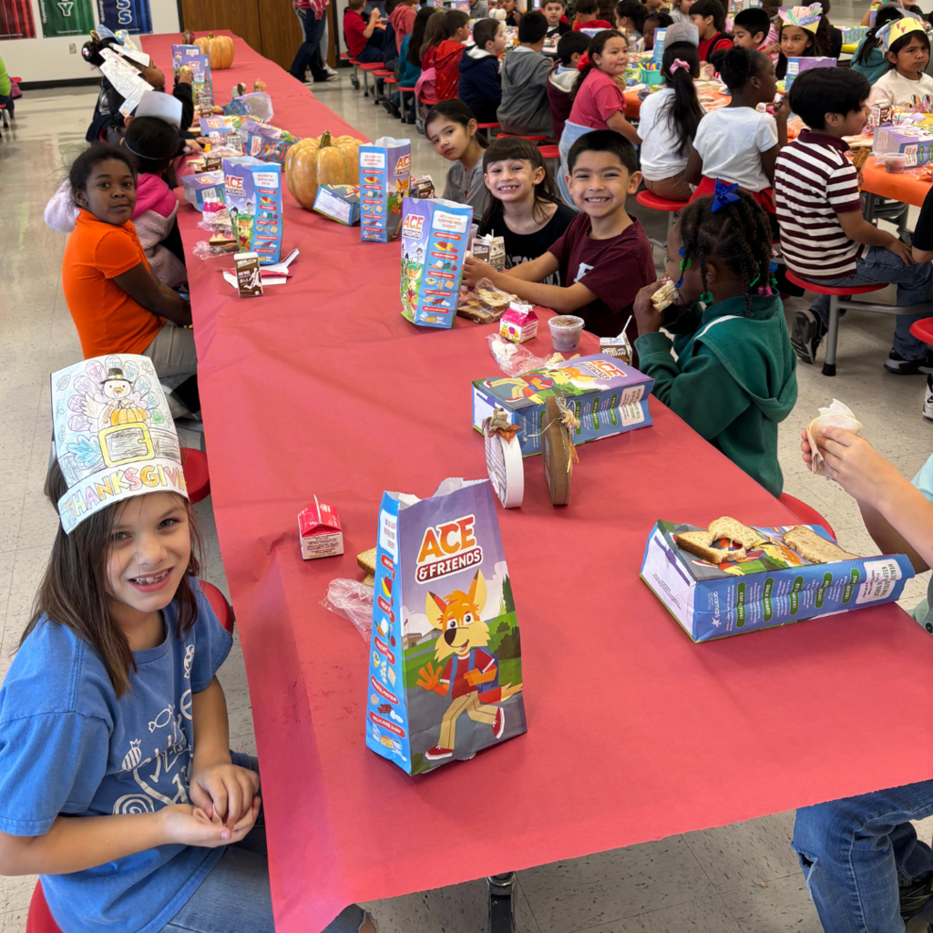 kids at cafeteria table covered with a tablecloth