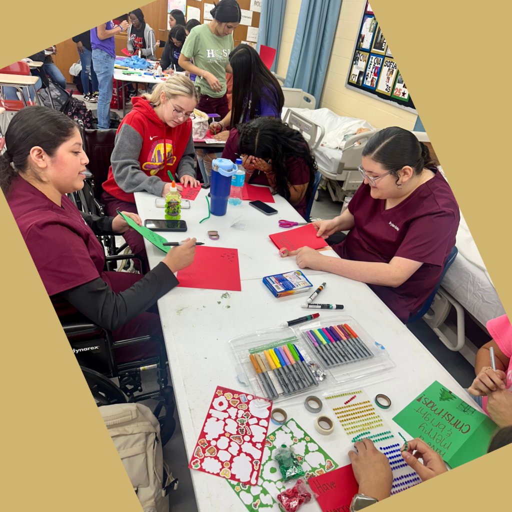 kids at desks working on the cards