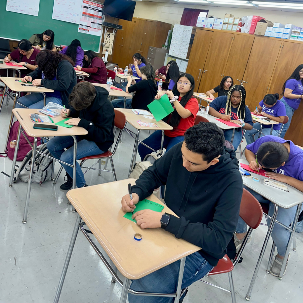 kids at desks working on the cards