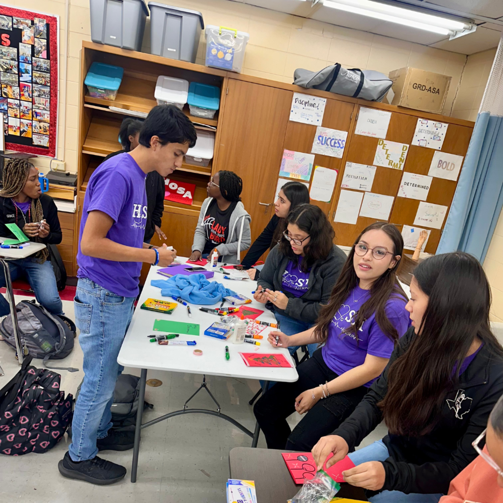 kids at desks working on the cards