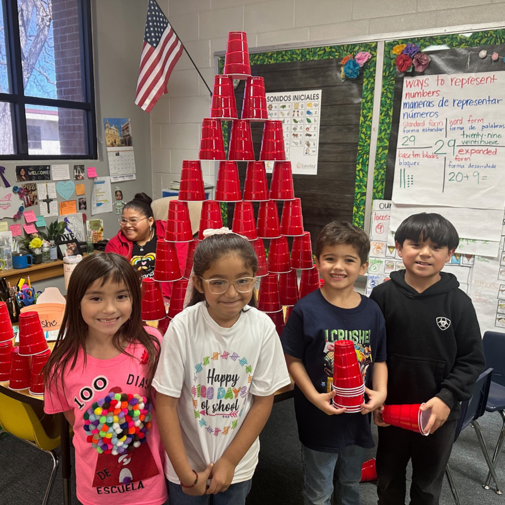 kids around a stack of 100 red cups
