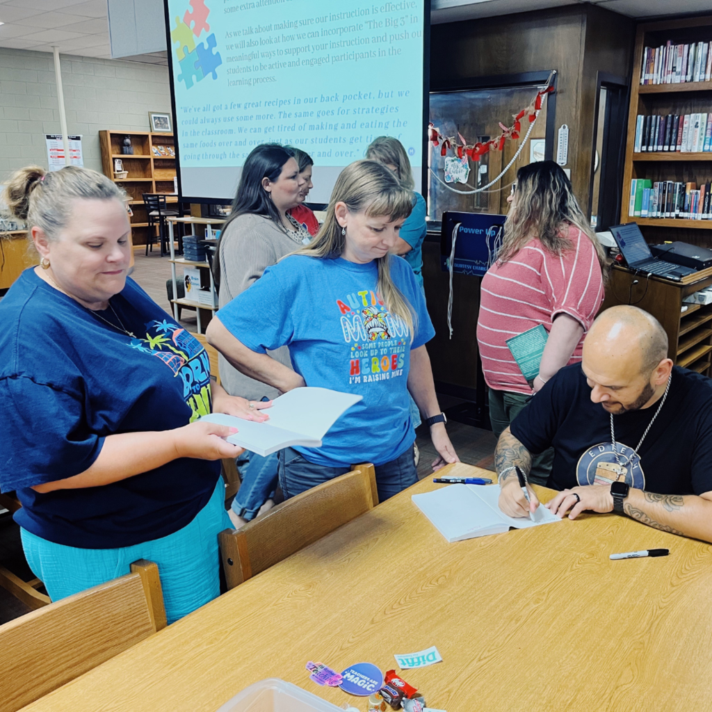 author signing the book for a teacher